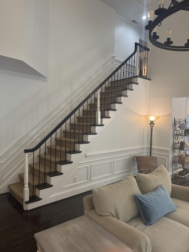 1060 Wilshire Way, Brentwood, TN 37027 - staircase with a decorative wall, a high ceiling, crown molding, a wainscoted wall, and wood finished floors