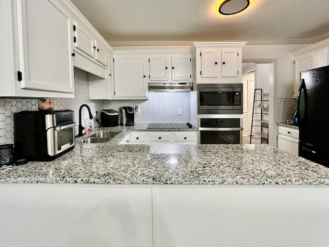 1307 Tomahawk Trce, Murfreesboro, TN 37129 - kitchen featuring black appliances, under cabinet range hood, white cabinetry, decorative backsplash, and light stone countertops