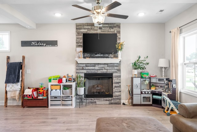 1098 Eagles View Dr, Clarksville, TN 37040 - living area featuring a fireplace, a ceiling fan, and wood finished floors