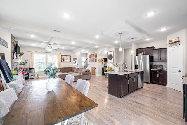 1098 Eagles View Dr, Clarksville, TN 37040 - dining room with recessed lighting, light wood finished floors, ceiling fan, beamed ceiling, and stairs