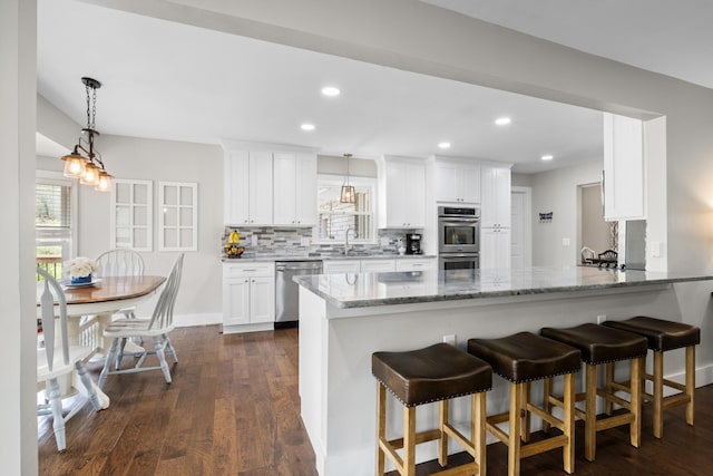 2913 New Hope Rd, Hendersonville, TN 37075 - kitchen featuring stainless steel appliances, decorative backsplash, dark wood finished floors, white cabinetry, and light stone countertops