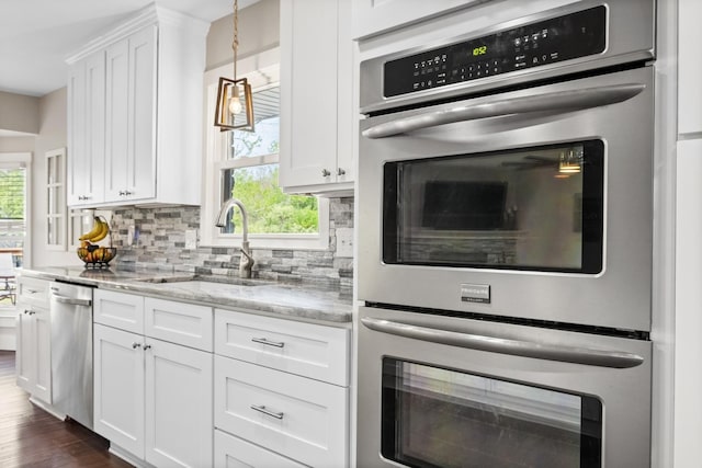 2913 New Hope Rd, Hendersonville, TN 37075 - kitchen featuring appliances with stainless steel finishes, decorative backsplash, white cabinetry, and light stone counters