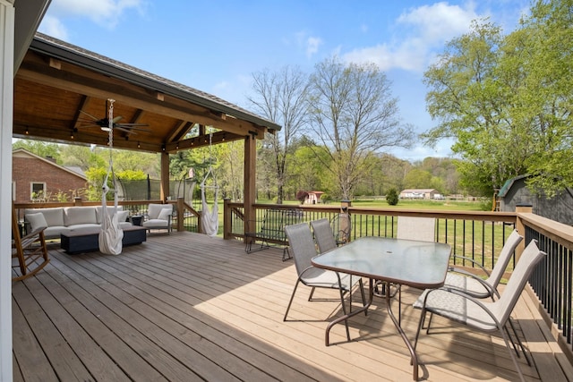 2913 New Hope Rd, Hendersonville, TN 37075 - deck with an outdoor living space, outdoor dining area, a ceiling fan, and a lawn