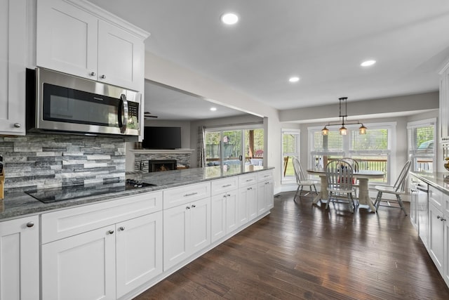 2913 New Hope Rd, Hendersonville, TN 37075 - kitchen featuring stainless steel microwave, black electric cooktop, healthy amount of natural light, backsplash, and recessed lighting