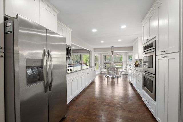 2913 New Hope Rd, Hendersonville, TN 37075 - kitchen with appliances with stainless steel finishes, dark wood-style floors, white cabinetry, recessed lighting, and light countertops