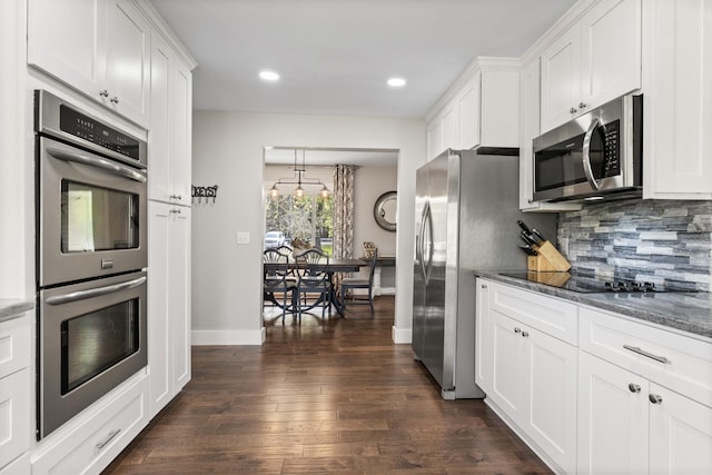 2913 New Hope Rd, Hendersonville, TN 37075 - kitchen with appliances with stainless steel finishes, decorative backsplash, white cabinetry, dark wood-style floors, and dark stone counters