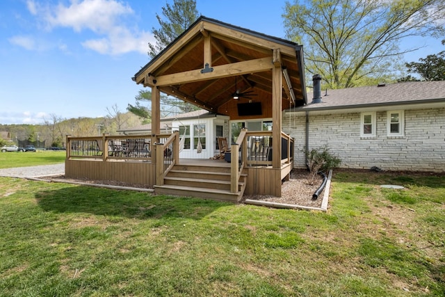 2913 New Hope Rd, Hendersonville, TN 37075 - rear view of property featuring a ceiling fan, a wooden deck, a lawn, and a chimney