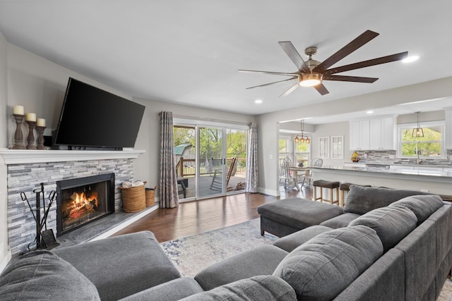2913 New Hope Rd, Hendersonville, TN 37075 - living room featuring wood finished floors, a stone fireplace, ceiling fan, and recessed lighting