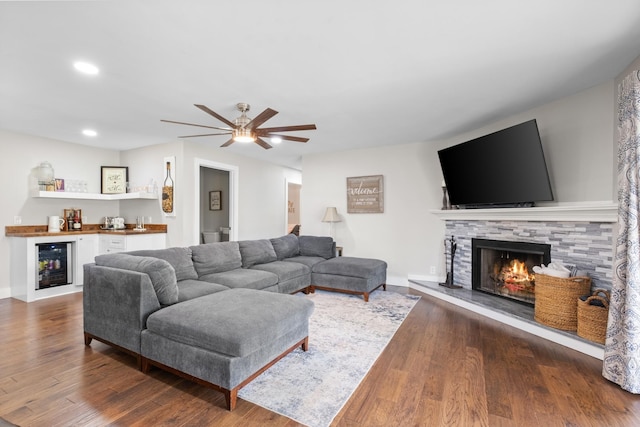 2913 New Hope Rd, Hendersonville, TN 37075 - living area with beverage cooler, a dry bar, a ceiling fan, a fireplace, and dark wood-type flooring