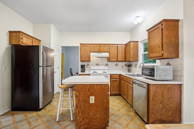 1438 Brighton Cir, Old Hickory, TN 37138 - kitchen with appliances with stainless steel finishes, light flooring, under cabinet range hood, and a center island