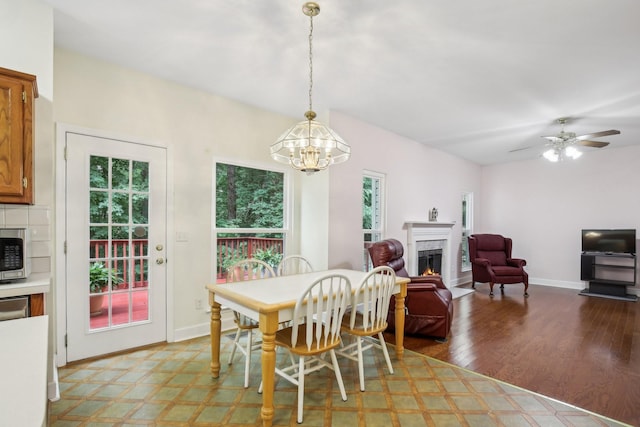 1438 Brighton Cir, Old Hickory, TN 37138 - dining room with healthy amount of natural light, a chandelier, a warm lit fireplace, and ceiling fan