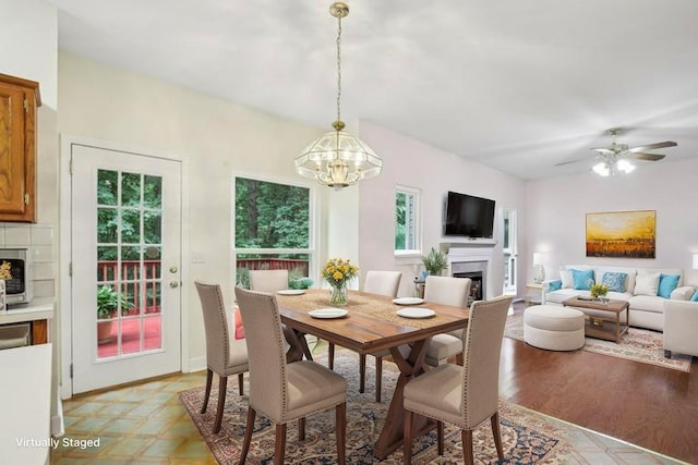 1438 Brighton Cir, Old Hickory, TN 37138 - dining room featuring a fireplace, a chandelier, a ceiling fan, and light wood-style floors