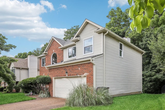 1438 Brighton Cir, Old Hickory, TN 37138 - view of side of home featuring brick siding, driveway, an attached garage, a chimney, and a yard