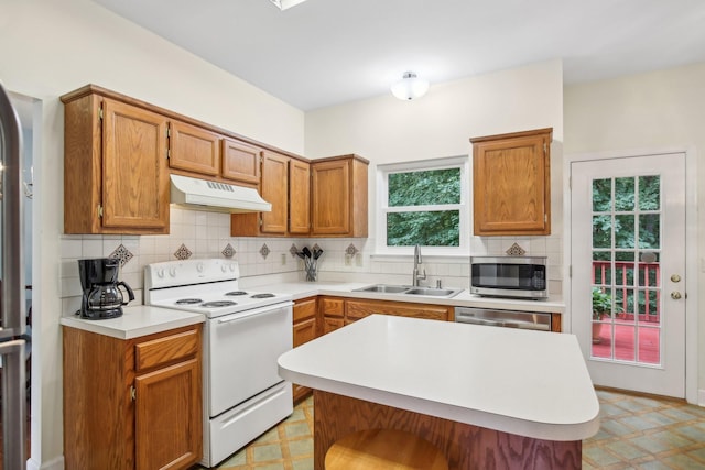 1438 Brighton Cir, Old Hickory, TN 37138 - kitchen featuring stainless steel appliances, under cabinet range hood, light countertops, backsplash, and brown cabinetry