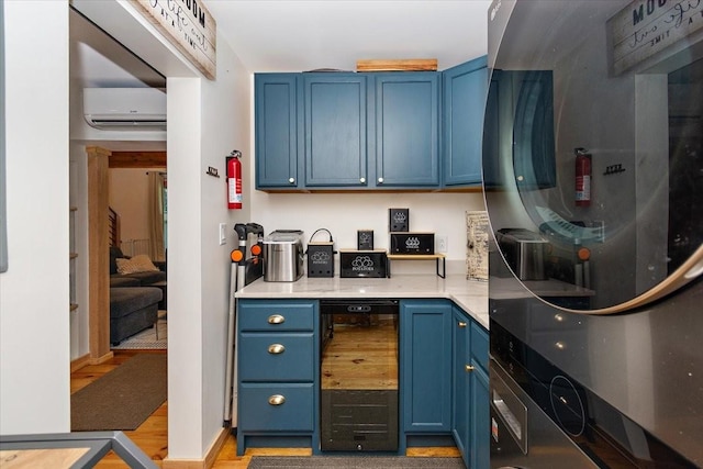 145 W Hollis Chapel Rd, Portland, TN 37148 - kitchen featuring blue cabinets, beverage cooler, a wall unit AC, fridge, and light countertops