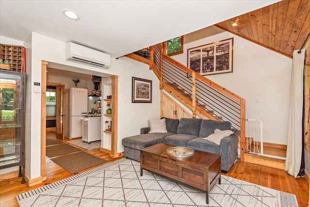 145 W Hollis Chapel Rd, Portland, TN 37148 - living room with a wall mounted air conditioner, wood finished floors, stairs, recessed lighting, and lofted ceiling