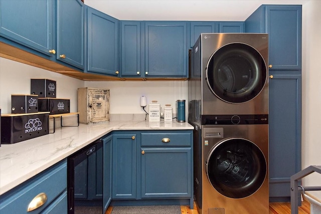 145 W Hollis Chapel Rd, Portland, TN 37148 - laundry room with stacked washer and clothes dryer, cabinet space, and wood finished floors