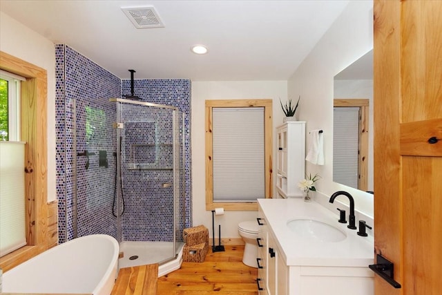 145 W Hollis Chapel Rd, Portland, TN 37148 - full bathroom with a stall shower, vanity, wood finished floors, a freestanding bath, and recessed lighting