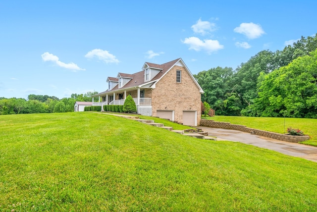 2430 Underwood Rd, Cunningham, TN 37052 - view of home's exterior featuring a garage, concrete driveway, brick siding, a lawn, and a storage unit