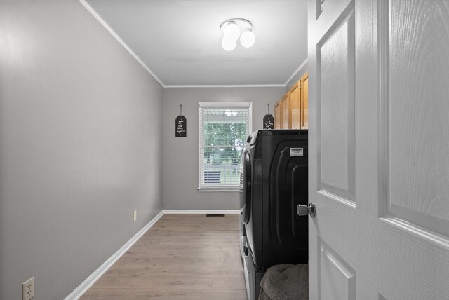 2430 Underwood Rd, Cunningham, TN 37052 - exercise room with washer / clothes dryer, light wood-type flooring, and ornamental molding