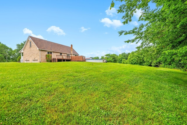 2430 Underwood Rd, Cunningham, TN 37052 - view of grassy yard featuring a deck and an attached garage