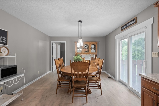 2430 Underwood Rd, Cunningham, TN 37052 - dining room featuring light wood finished floors and a textured ceiling