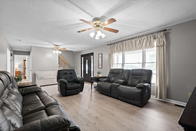 2430 Underwood Rd, Cunningham, TN 37052 - living room with a textured ceiling, ceiling fan, stairway, and wood finished floors