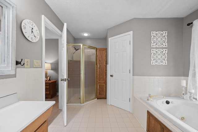 2430 Underwood Rd, Cunningham, TN 37052 - full bathroom with a shower stall, a tub with jets, tile patterned flooring, tile walls, and vanity
