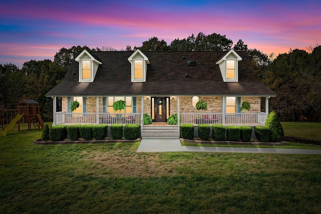 2430 Underwood Rd, Cunningham, TN 37052 - cape cod home with covered porch, a lawn, and brick siding