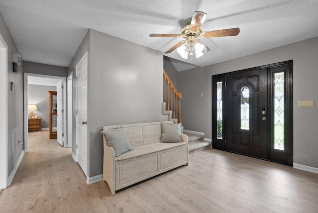 2430 Underwood Rd, Cunningham, TN 37052 - entrance foyer featuring light wood-type flooring, stairway, a ceiling fan, and a textured ceiling