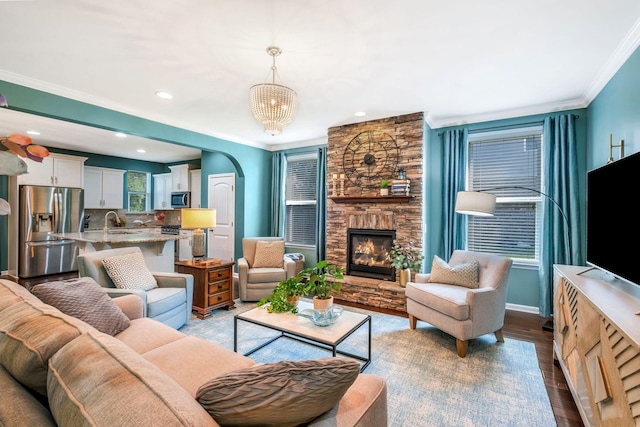 625 Foster Ln, Mount Juliet, TN 37122 - living room with arched walkways, ornamental molding, a fireplace, recessed lighting, and wood finished floors