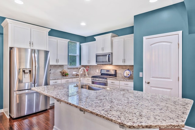 625 Foster Ln, Mount Juliet, TN 37122 - kitchen featuring stainless steel appliances, dark wood finished floors, white cabinetry, an island with sink, and backsplash