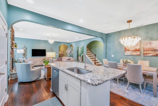 625 Foster Ln, Mount Juliet, TN 37122 - kitchen featuring arched walkways, stainless steel dishwasher, a chandelier, dark wood-style flooring, and light stone countertops