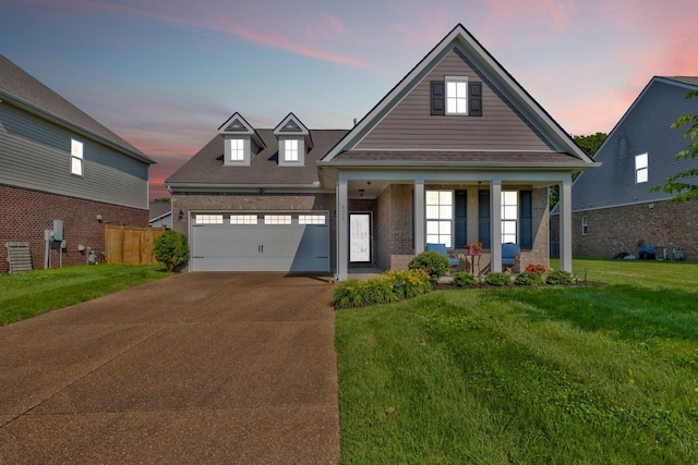 625 Foster Ln, Mount Juliet, TN 37122 - view of front of house with brick siding, covered porch, a yard, concrete driveway, and a garage