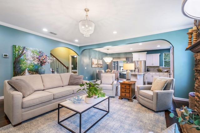 625 Foster Ln, Mount Juliet, TN 37122 - living room with arched walkways, a chandelier, stairway, recessed lighting, and light wood-style floors
