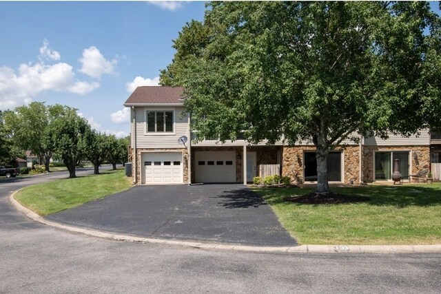 133 Tanasi Shr, Gallatin, TN 37066 - view of front of home featuring driveway, a front yard, and stone siding