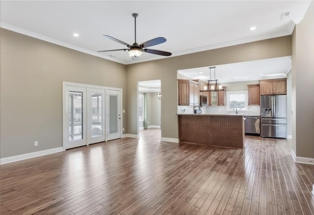 133 Tanasi Shr, Gallatin, TN 37066 - unfurnished living room with wood finished floors, ceiling fan, crown molding, and recessed lighting
