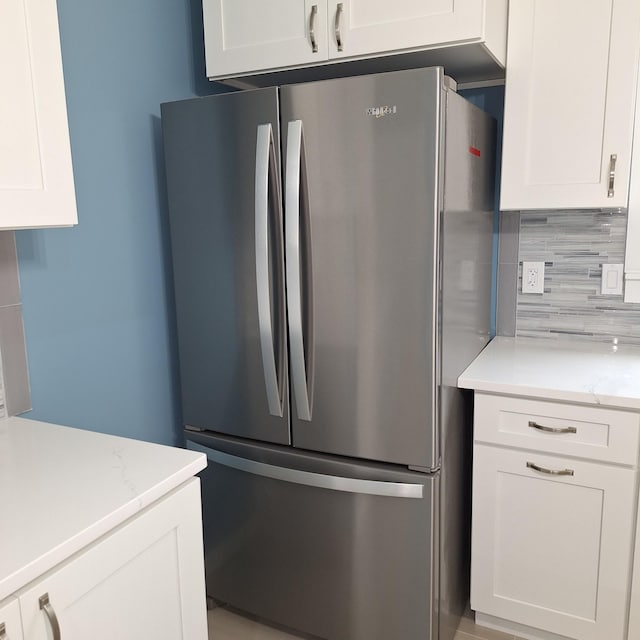 148 Quita Cir, Lebanon, TN 37087 - kitchen with freestanding refrigerator, white cabinets, and tasteful backsplash