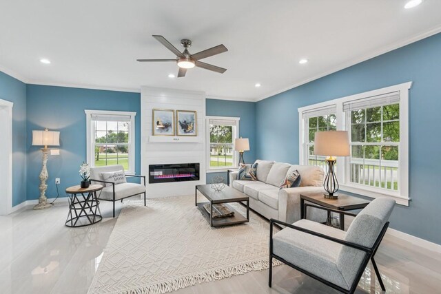 148 Quita Cir, Lebanon, TN 37087 - living room featuring crown molding, recessed lighting, ceiling fan, a large fireplace, and wood finished floors