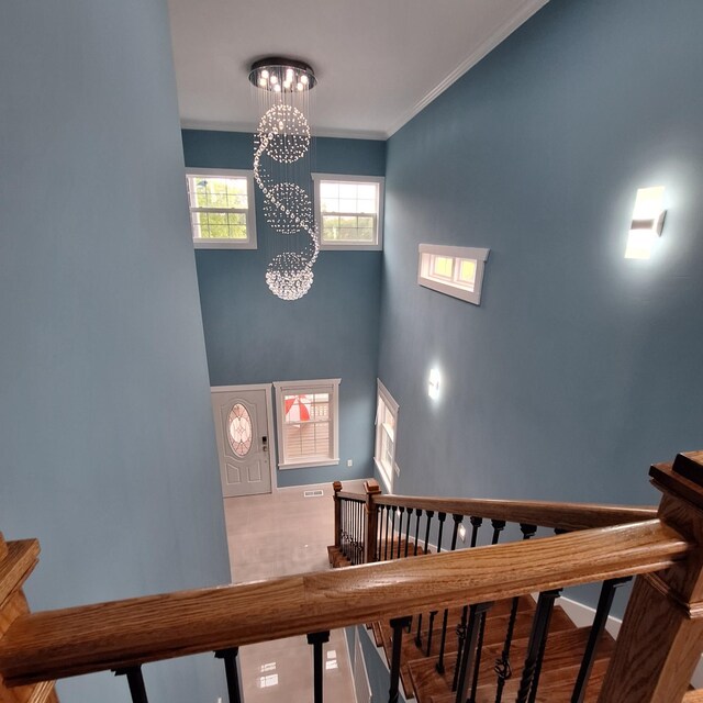 148 Quita Cir, Lebanon, TN 37087 - stairs with a chandelier, ornamental molding, and a towering ceiling
