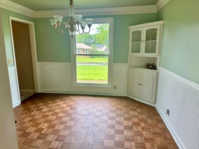 303 Revere Ln, Franklin, TN 37064 - unfurnished dining area featuring wainscoting and a chandelier
