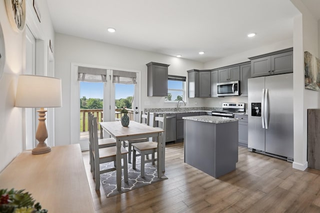 1202 Oak Grove Rd, Dickson, TN 37055 - kitchen with appliances with stainless steel finishes, a center island, gray cabinets, dark wood finished floors, and recessed lighting
