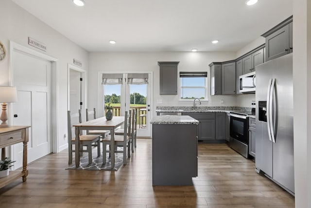 1202 Oak Grove Rd, Dickson, TN 37055 - kitchen featuring stainless steel appliances, a center island, recessed lighting, light stone countertops, and dark wood-style flooring