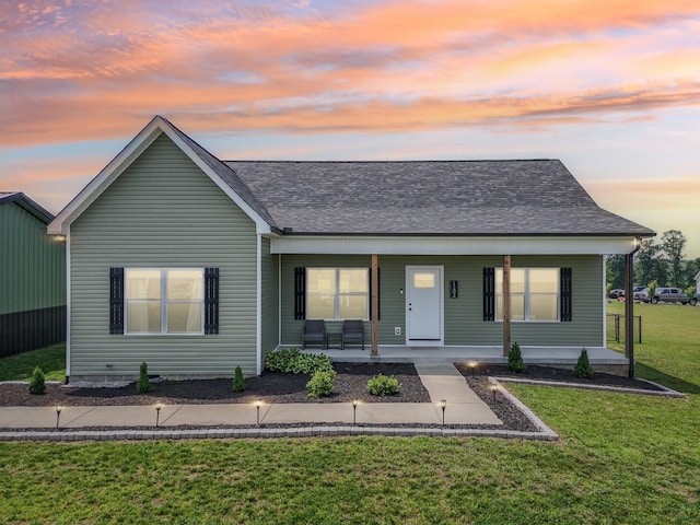 1202 Oak Grove Rd, Dickson, TN 37055 - view of front of home with covered porch, a front yard, and roof with shingles