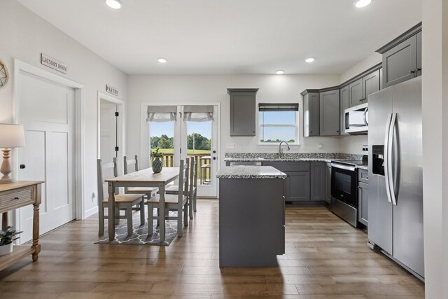 1202 Oak Grove Rd, Dickson, TN 37055 - kitchen featuring stainless steel appliances, a center island, recessed lighting, light stone countertops, and dark wood-style flooring