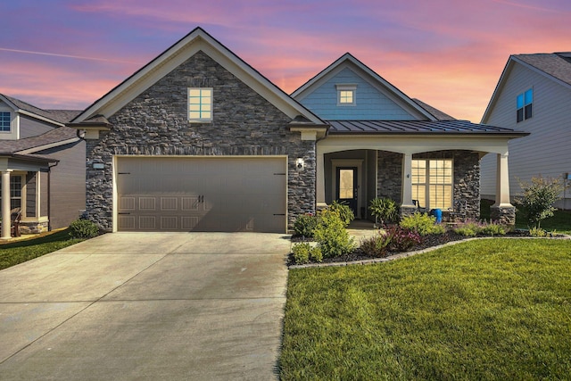 3002 Obion Pass, Spring Hill, TN 37174 - view of front of property with stone siding, a yard, driveway, a standing seam roof, and a garage