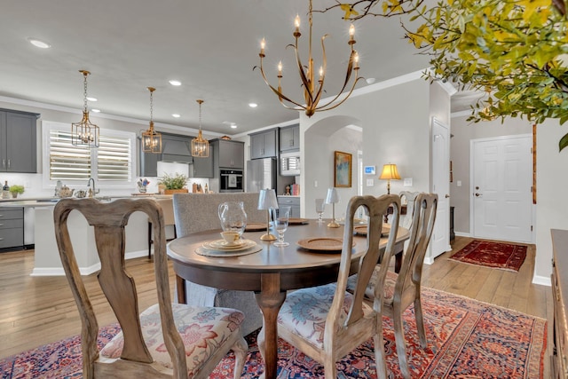 3002 Obion Pass, Spring Hill, TN 37174 - dining area with ornamental molding, recessed lighting, a chandelier, arched walkways, and light wood-style floors