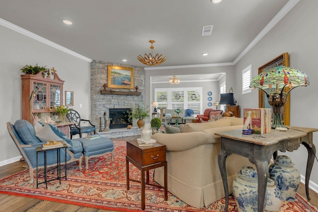3002 Obion Pass, Spring Hill, TN 37174 - living room with ornamental molding, wood finished floors, a stone fireplace, a chandelier, and recessed lighting