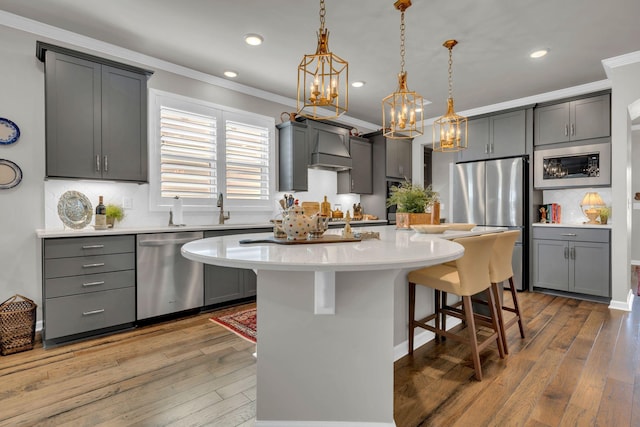 3002 Obion Pass, Spring Hill, TN 37174 - kitchen with stainless steel appliances, ornamental molding, a chandelier, a breakfast bar area, and light countertops