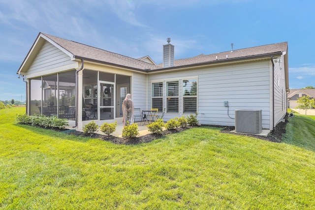 3002 Obion Pass, Spring Hill, TN 37174 - rear view of property with a sunroom, a chimney, a lawn, and a patio area
